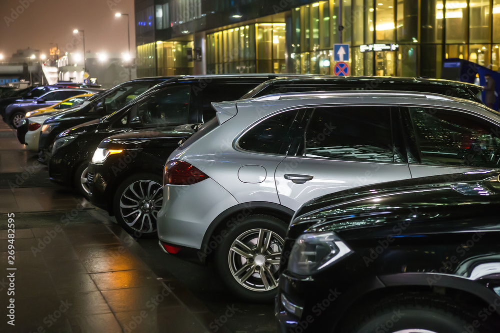 Cars in the parking lot on the street at night Cars in the parking lot on the street at night