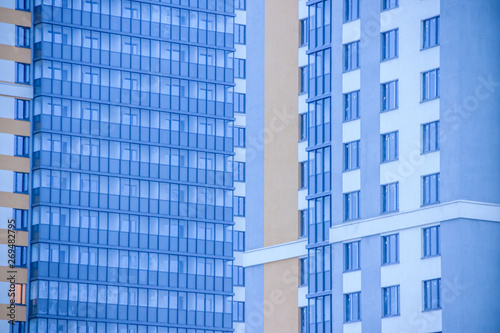 Windows of a high multi-storey residential building. High building. Residential high-rise building.