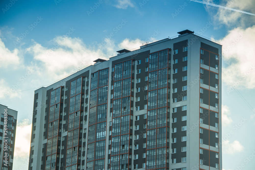 Fototapeta premium Windows of a high multi-storey residential building. High building. Residential high-rise building.