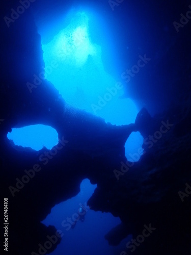 A diver swims in the underwater cave.