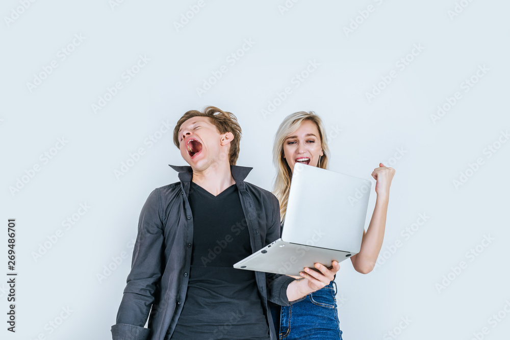 Portrait of happy young couple using laptop computer in studio Portrait of happy young couple using laptop computer in studio