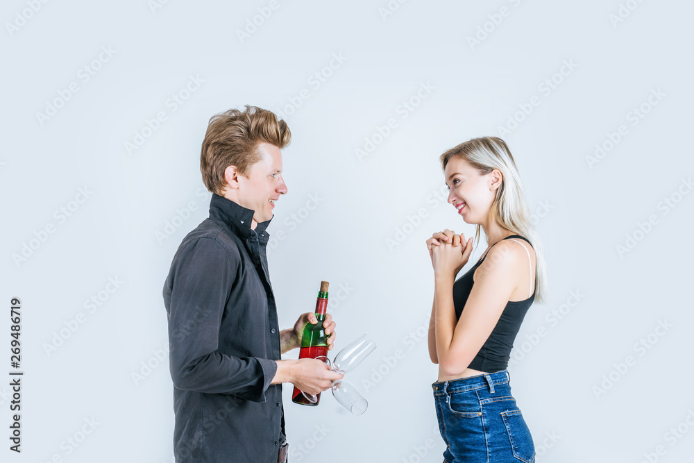 Portrait of happy young couple drinking wine in studio Portrait of happy young couple drinking wine in studio