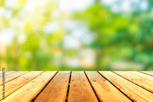 Selective focus of empty old wood on blur nature green leaf with bokeh.