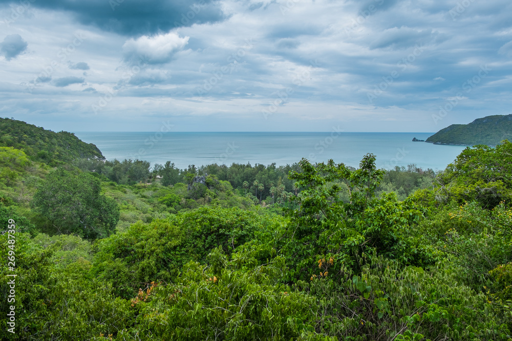 On the green mountain by the beach Overlooking the sea and sky On the green mountain by the beach Overlooking the sea and sky
