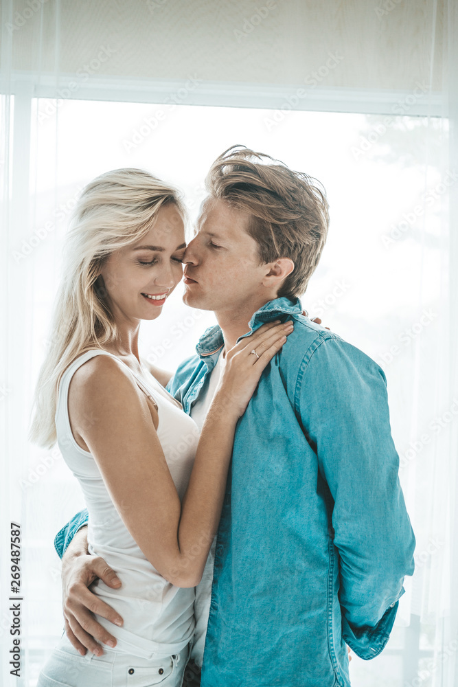 Fototapeta premium Happy Couple Playing together in the bedroom