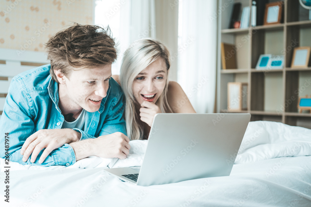 Happy couple Using laptop computer on the bed Happy couple Using laptop computer on the bed