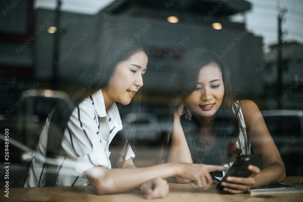 Two beautiful women talking everything together at coffee shop cafe Two beautiful women talking everything together at coffee shop cafe