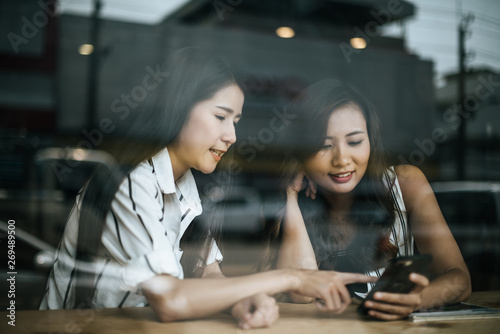 Two beautiful women talking everything together at coffee shop cafe