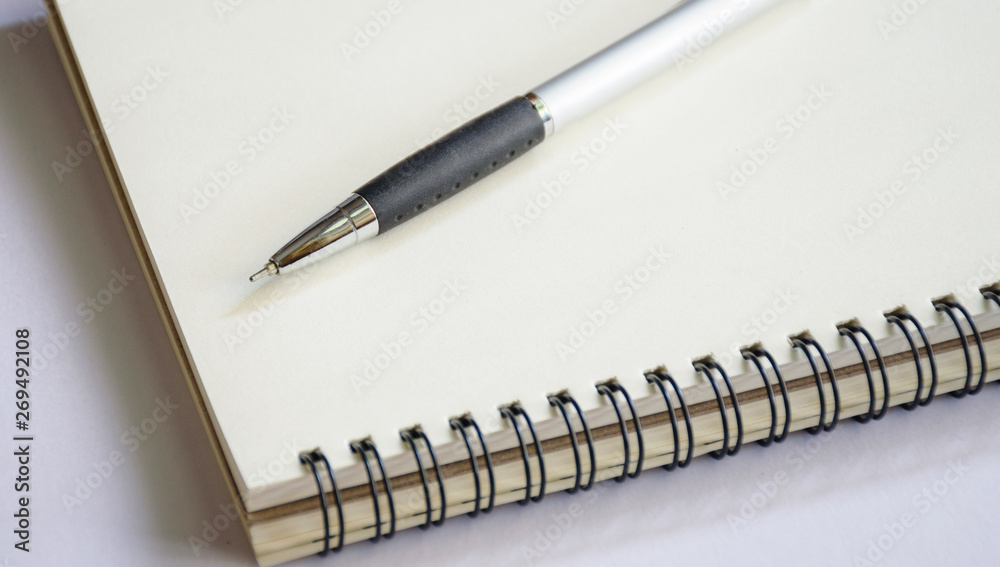 Notebook with pen with space to put text on a white background Notebook with pen with space to put text on a white background