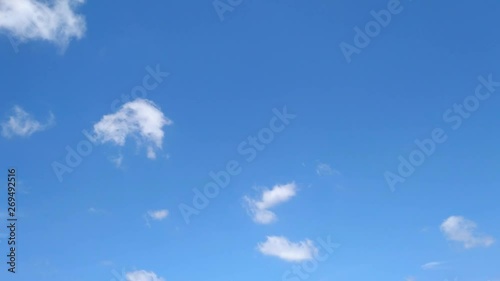 The clouds are moving fast in the sky in the daytime bright.