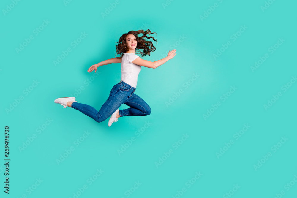 Full length body size profile side view of her she nice-looking attractive lovely cheerful cheery slim fit thin wavy-haired lady having fun time isolated on bright vivid shine blue background