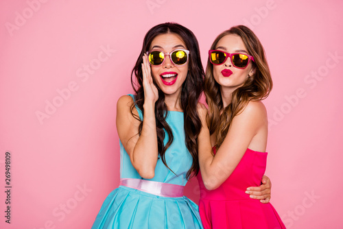 Close up photo two beautiful she her ladies foreign travelers tourism send air kiss handsome strangers coquette wear sun specs shiny colorful dresses formal-wear isolated pink rose vivid background © deagreez