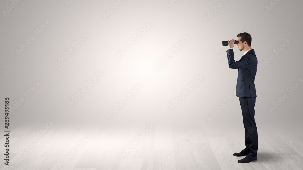 Businessman looking forward with binoculars in an empty space
Businessman looking forward with binoculars in an empty space