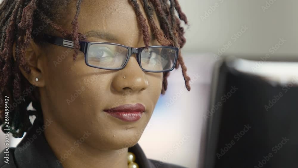 Close up of a young woman's face looking at a computer screen