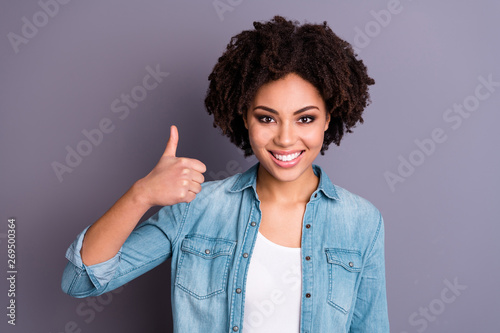 Portrait of cute positive lady youngster advertise choice decision approve agree tip sale news discount feel glad content dressed jeans isolated grey background