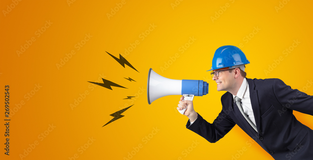 Fototapeta premium Young architect constructor yelling with megaphone and copyspace