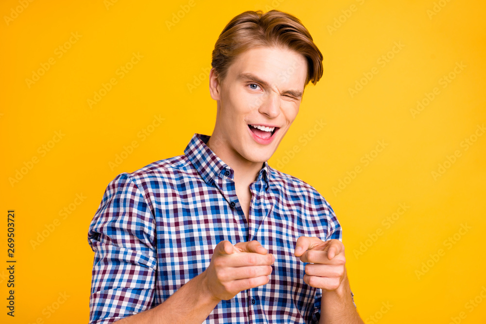 Close up photo amazing youngster he him his man arms hands fingers air blink one eye indicating I pick only you wearing casual plaid checkered shirt outfit isolated yellow bright background