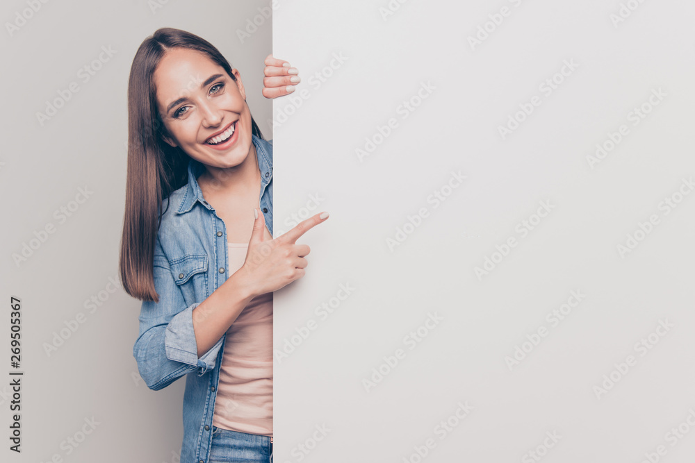 Portrait of her she nice attractive lovely shine cheerful cheery positive straight-haired lady pointing forefinger at big large promotion ad advert isolated over light white gray background - obrazy, fototapety, plakaty 
