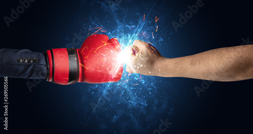 Two hands fighting with light, glow, spark and smoke concept   © ra2 studio