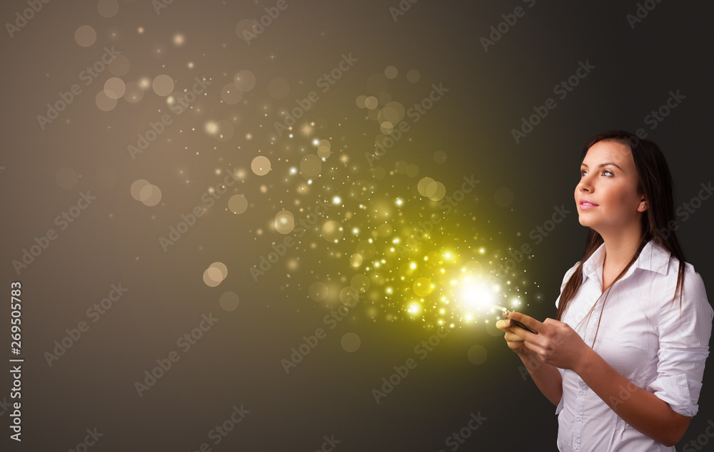 Person using phone with gold sparkling concept
Person using phone with gold sparkling concept