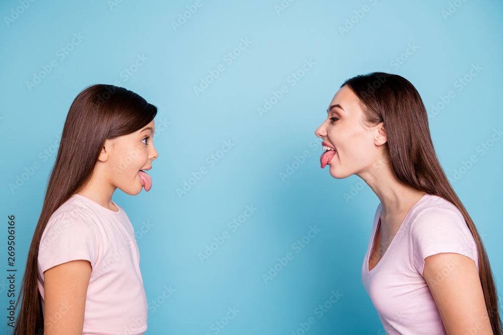 Close-up profile side view portrait of two nice attractive naughty cheerful cheery straight-haired girls having fun fooling isolated over bright vivid shine green blue turquoise background Close-up profile side view portrait of two nice attractive naughty cheerful cheery straight-haired girls having fun fooling isolated over bright vivid shine green blue turquoise background