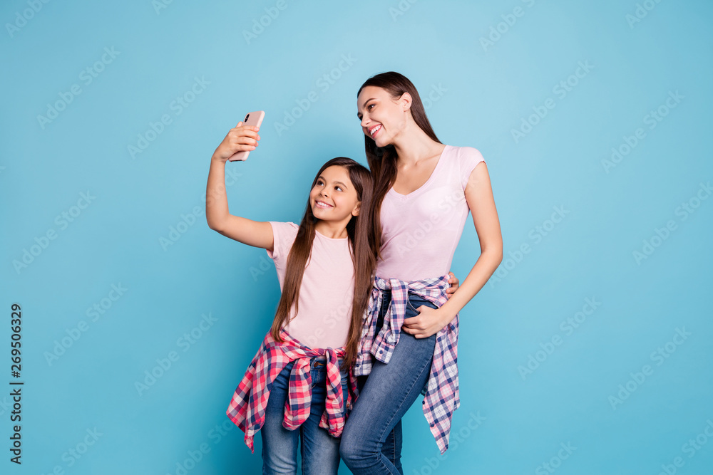 Portrait of two nice charming attractive lovely slim fit thin cheerful cheery straight-haired girls posing taking making selfie isolated on bright vivid shine green blue turquoise background Portrait of two nice charming attractive lovely slim fit thin cheerful cheery straight-haired girls posing taking making selfie isolated on bright vivid shine green blue turquoise background