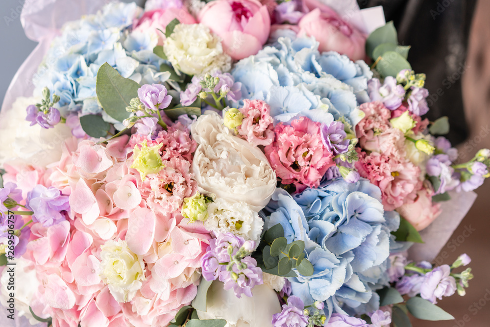 Large Beautiful bouquet of mixed flowers in woman hand. Floral shop concept . Beautiful fresh cut bouquet. Flowers delivery Large Beautiful bouquet of mixed flowers in woman hand. Floral shop concept . Beautiful fresh cut bouquet. Flowers delivery