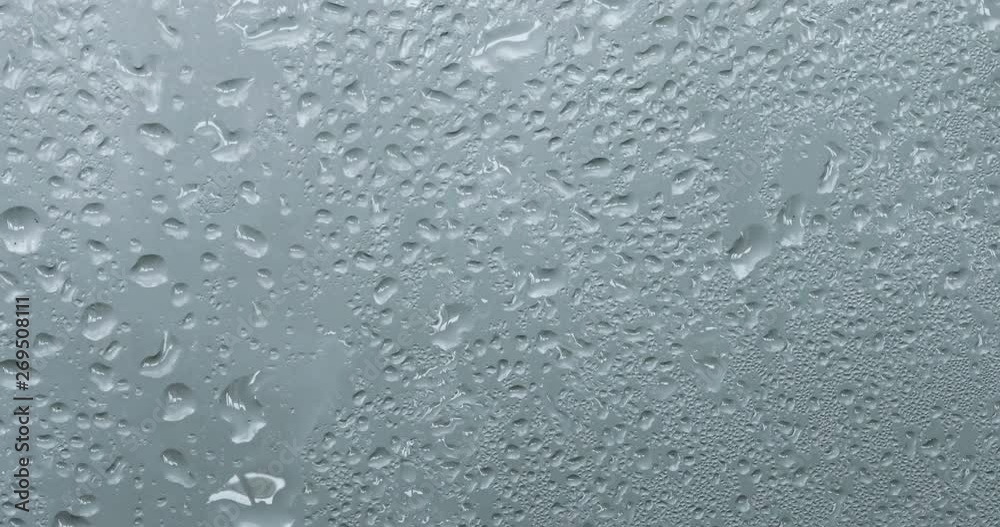 close up a steam mirror with rain drop on the glass window , rainy season background close up a steam mirror with rain drop on the glass window , rainy season background