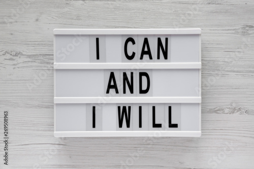 Lightbox with 'I can and I will' words on a white wooden surface, top view. Overhead, from above. Flat lay. © Liudmyla