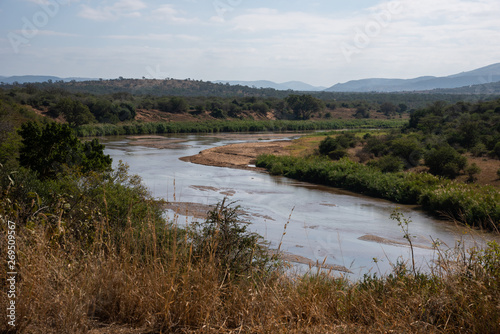 The Black Umfolozi River meandering through the African bush, South Africa.
