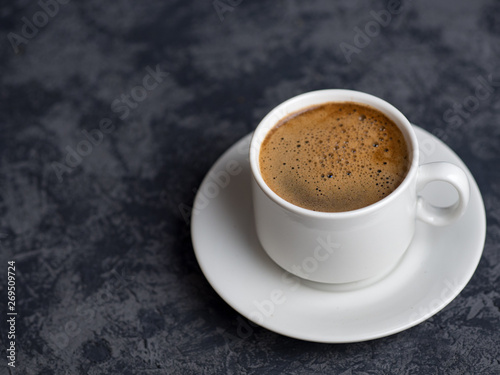 White espresso Cup on dark background with copyspace