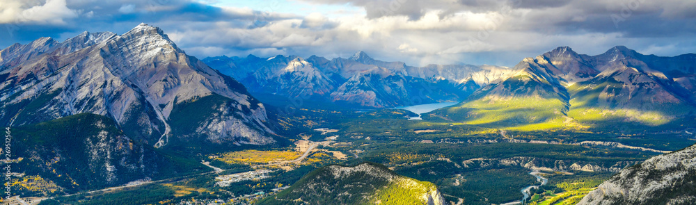 Panorama view over the town of Banff and the Canadian Rockies seen from Sulphur Mountain.You can go to the mountaintop with a gondola. - obrazy, fototapety, plakaty 