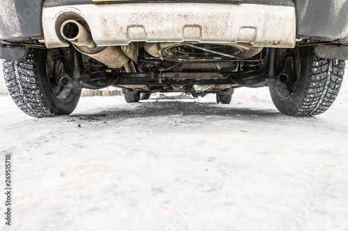 Картината върху платно Road clearance. Bottom of the car on a winter snowy road.