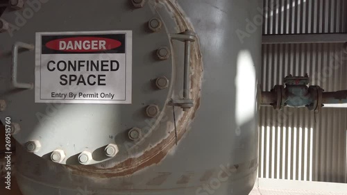 A very large confined space at a lead and zinc refinery showing confined space signage and entry points