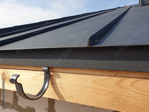 Vászonkép close up view of folded roof of house under construction with holders for gutter