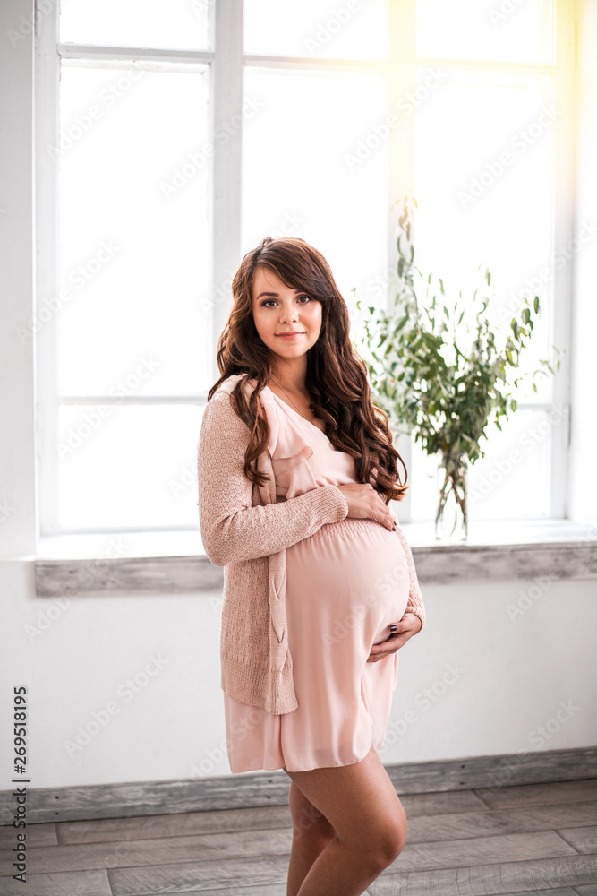 Beautiful smiling pregnant woman is holding belly Beautiful smiling pregnant woman is holding belly