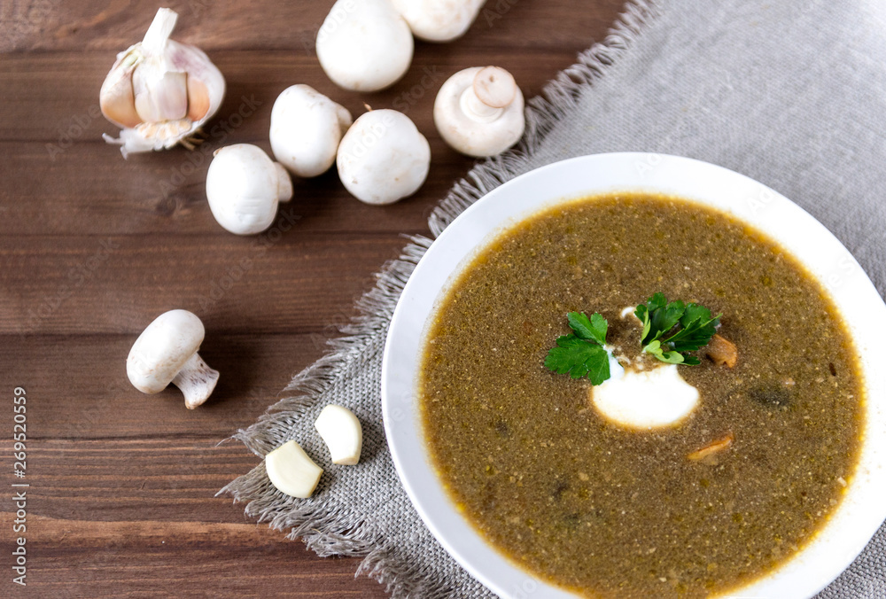 mushroom soup with sour cream and a sprig of parsley, champignons mushroom soup with sour cream and a sprig of parsley, champignons