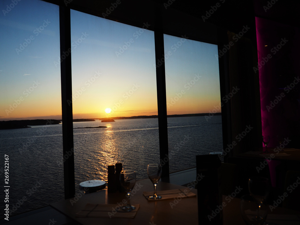 Fototapeta premium Cruise ship, with table and chair in the sunset at sea