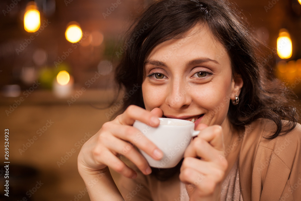 Young attractive woman smiling to camera in coffee shop Young attractive woman smiling to camera in coffee shop