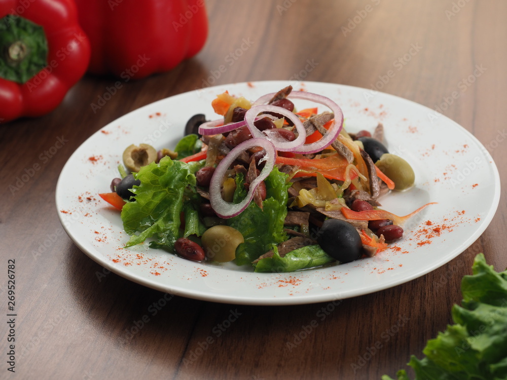 Salad with meat, olives, onions, beans and pepper