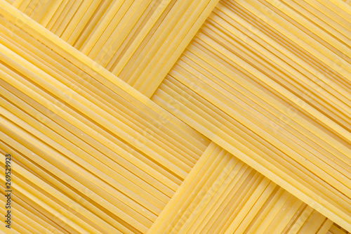 Diagonal geometric pattern of pasta bavette. Background image of pasta from durum wheat.