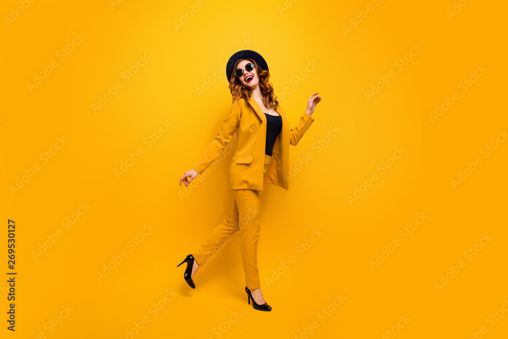 Full length side profile body size photo beautiful amazing funky she her lady walking down street perfect look tourism traveler wear specs formal-wear costume suit isolated yellow bright background Full length side profile body size photo beautiful amazing funky she her lady walking down street perfect look tourism traveler wear specs formal-wear costume suit isolated yellow bright background