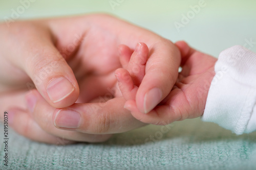 Baby and mom hand friendship care tenderness concept. Newborn new family