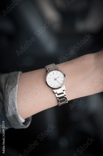 Women's wristwatch on the girl's hand. Women's gold watch. Time is money.