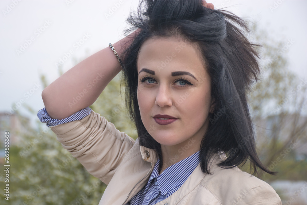Naklejka premium Magnificent passionate young brunette woman with perfect skin. Presenting your product. Expressive facial expressions. Copy space. Her hands near her face. 