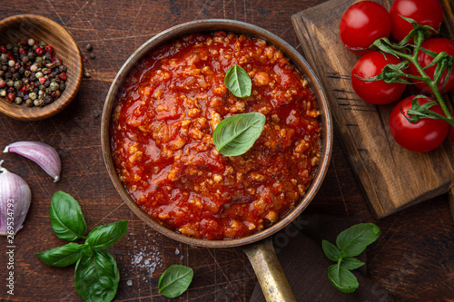 Traditional italian Bolognese sauce in saucepot photo