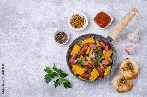 Slices of fried vegetables with sausages