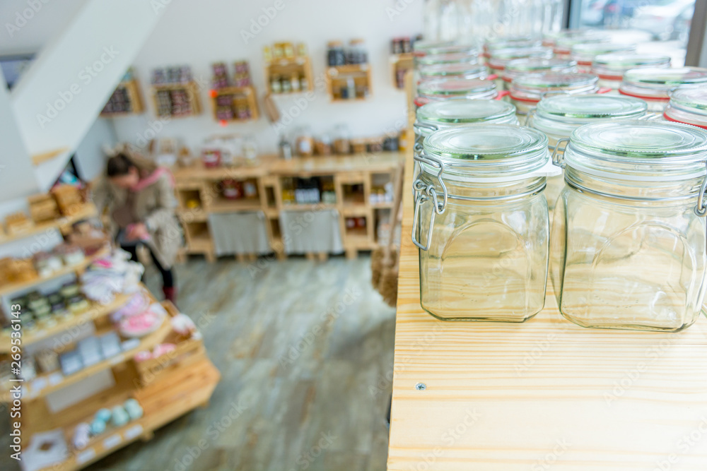 Closeup of empty glass jar in a zero waste shop. Closeup of empty glass jar in a zero waste shop.