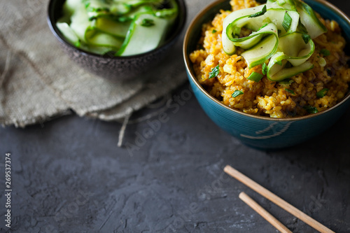 Traditional Burmese fried rice with shallots,turmeric and fresh cucumber strips mixed with chopped green onions and vinegar has been stir-fried in a wok and perfect for vegan. copy space,top view