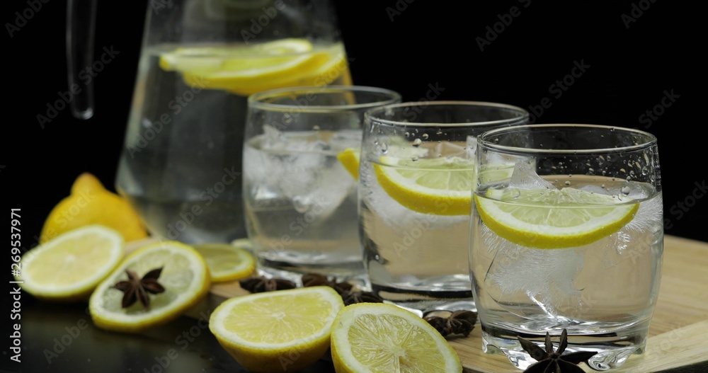Lemon juice in glass with ice and lemon slices. Lemon cocktail Lemon juice in glass with ice and lemon slices. Lemon cocktail